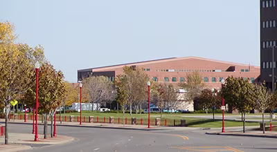 Exterior view of Apple Valley High School building with red lampposts in the foreground.