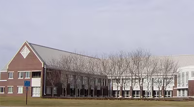 Exterior view of the Brooklyn Park City Hall and community center building under a clear sky.