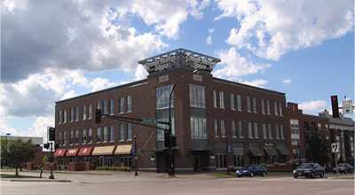 A brick multi-use building at Nicollet Avenue in Burnsville, Minnesota, featuring street-level retail.