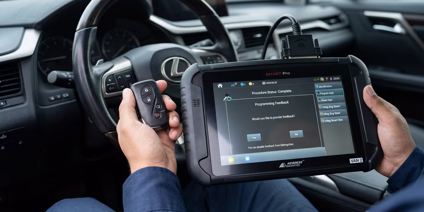 Technician programming a replacement key fob for a vehicle in Minneapolis