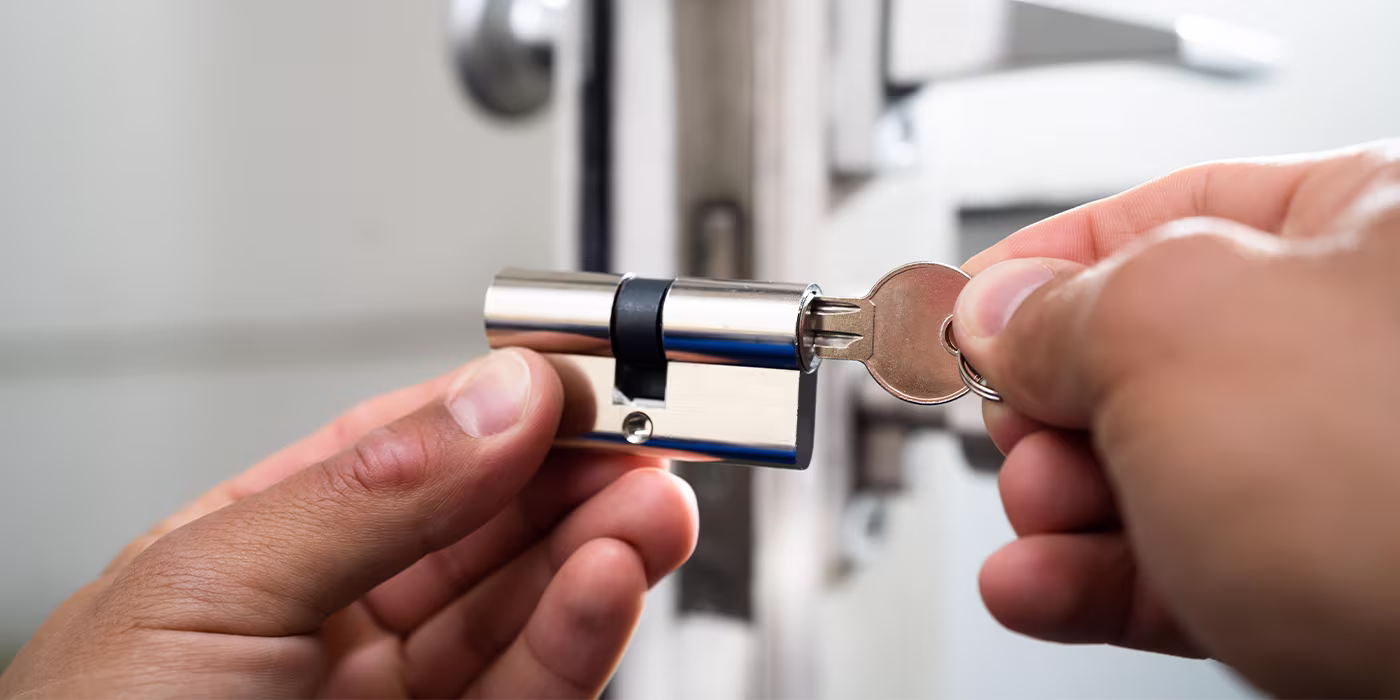 Locksmith installing a new door lock on a Minneapolis home